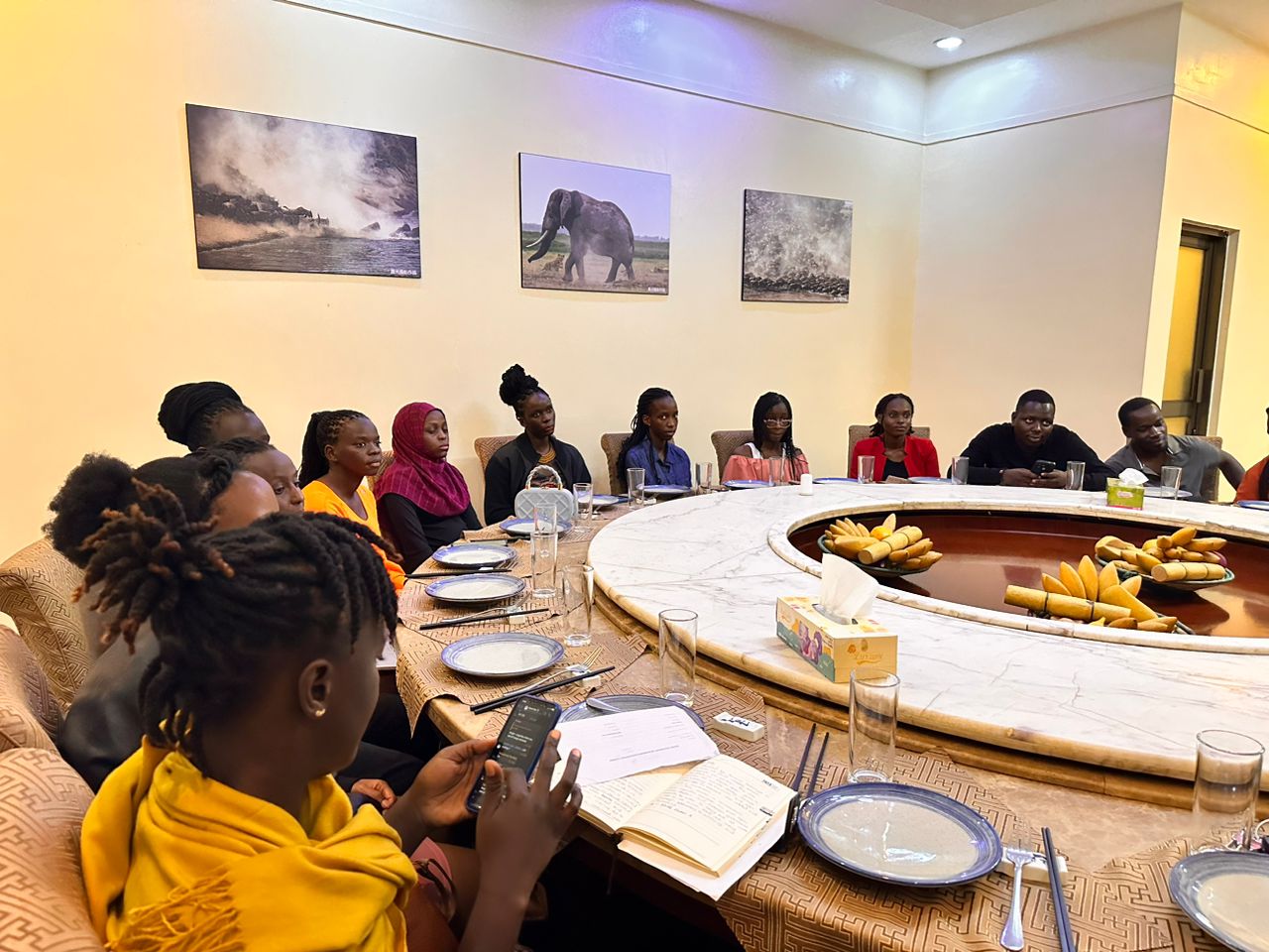 Participants at a round dinner table, discussing girls' education and empowerment at the Unite for Girls Night event.